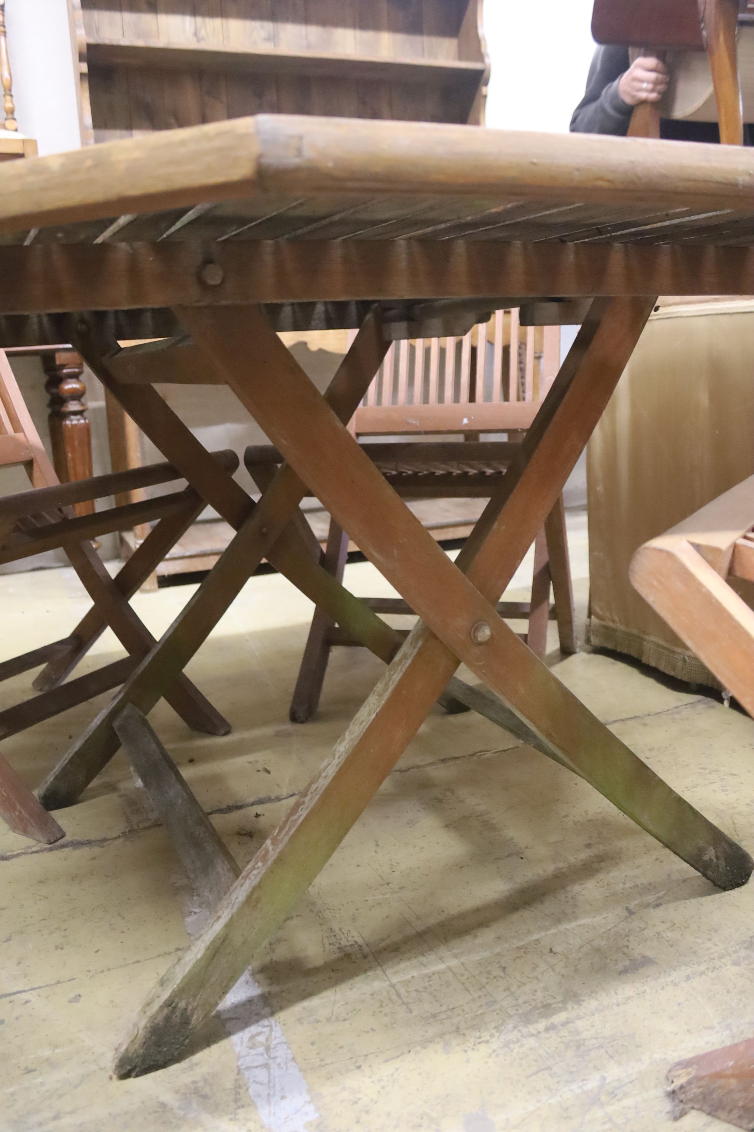 An octagonal teak garden table, width 111cm, height 69cm and four chairs